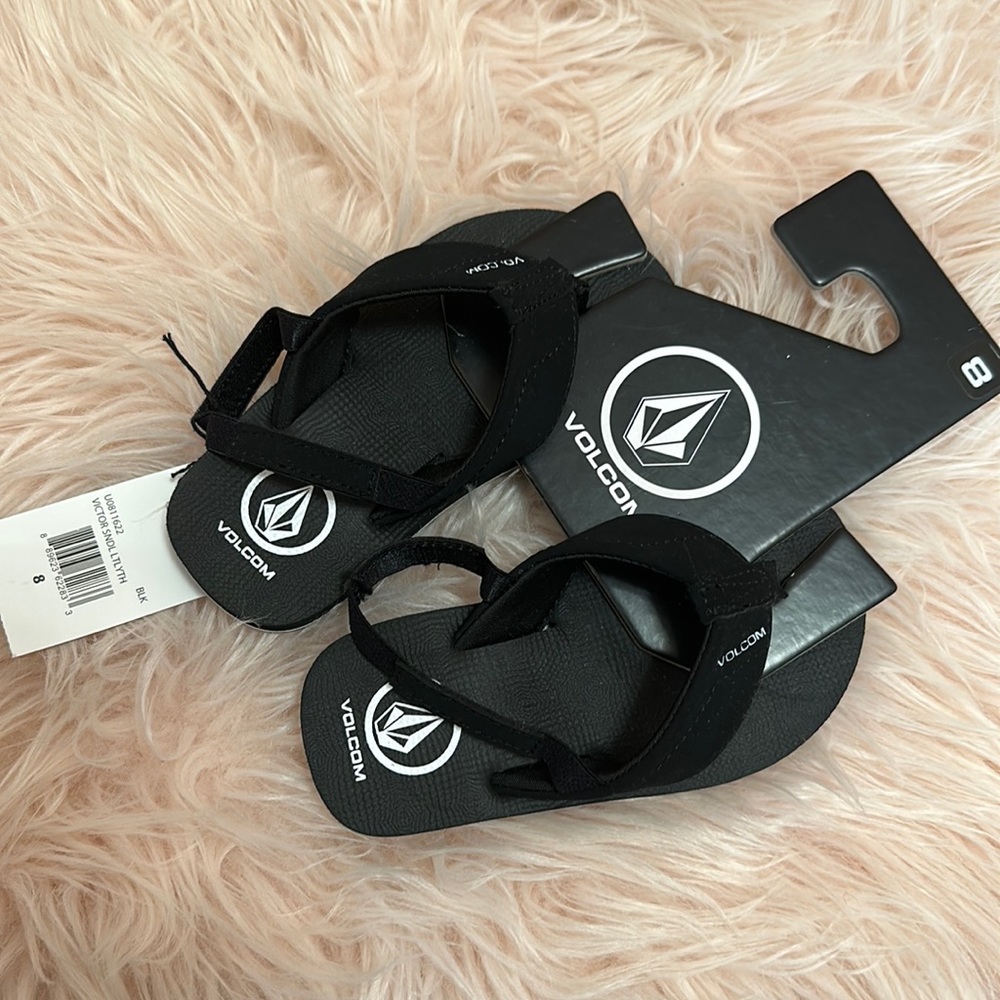 Toddler black a volcom flip flops. NWT size 8